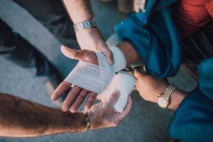 a person injured getting a bandage put on by another person